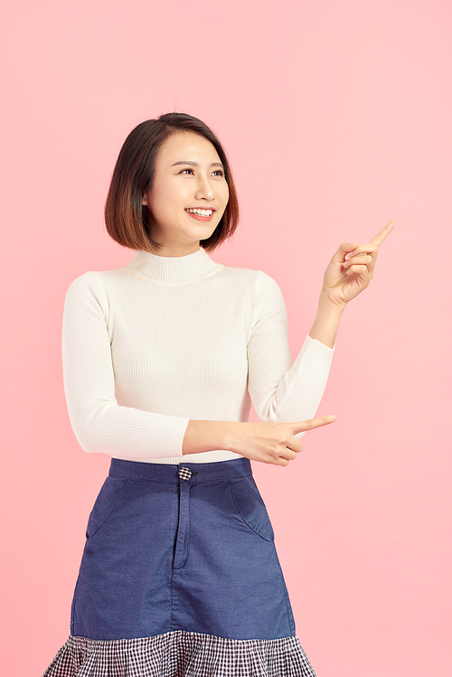 Businesswoman pressing button or something. Isolated on pink background