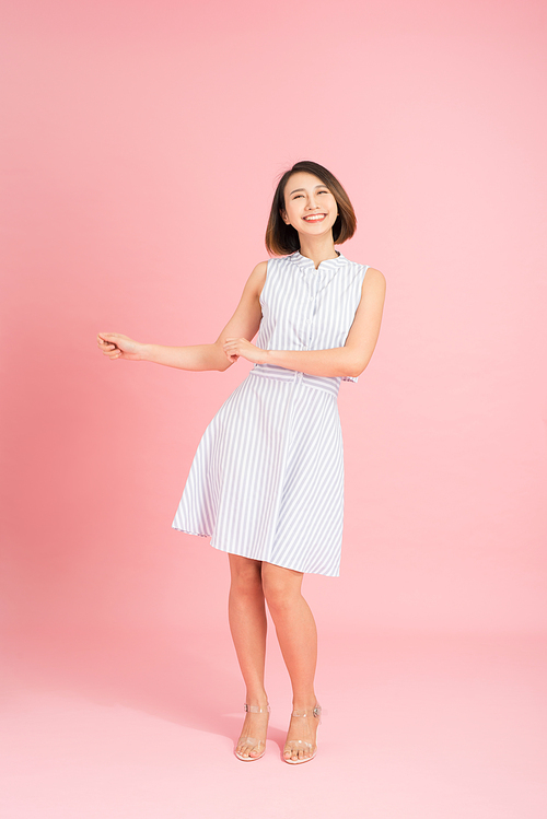 Full length photo of cheerful positive girl have fun on summer party event dance raise fingers up wear casual style clothing isolated over pink background