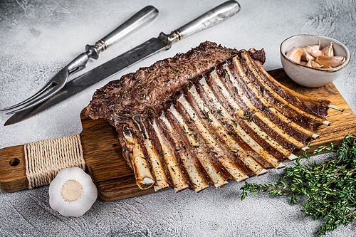 Charcoal Grilled French rack of Lamb Ribs Chops on cutting board. White background. Top view.