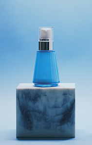 Serum bottle on blue background, luxury skincare products, beauty and cosmetics.