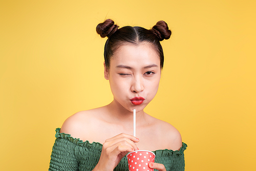 Beautiful crazy smiling asian woman girl with red lips drinking cola with straw