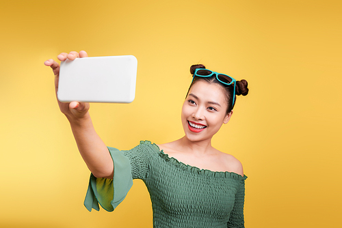 Young cheerful attractive asian woman taking selfies with smile.
