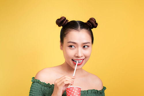 Beautiful crazy smiling asian woman girl with red lips drinking cola with straw