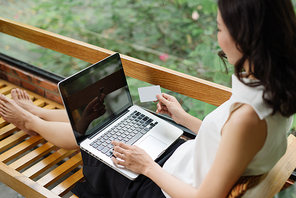Portrait of a Girl holding credit card and using laptop. Online shopping