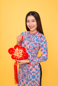 Vietnamese woman traditional festival costume Ao Dai holding attributes. Text mean Happiness.