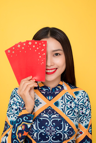 Vietnamese woman traditional festival costume Ao Da holding red money pockets. Tet holiday. Lunar New Year.