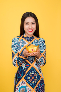 Vietnamese woman traditional festival costume Ao Dai. Tet holiday. Lunar New Year. Text mean rich.