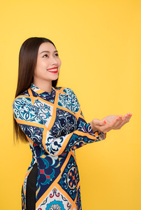 Vietnamese woman traditional festival costume Ao Dai gesture hands.