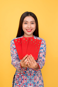 Beautiful asian woman on traditional festival costume Ao Dai holding lucky pocket money