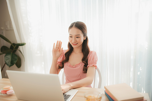 Beautiful Asian Young Woman Using Laptop Computer Working from Home in the Morning