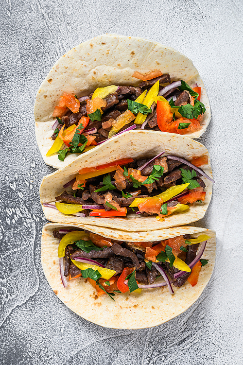 Mexican tacos with beef meat, onion and sweet pepper. White background. Top view.