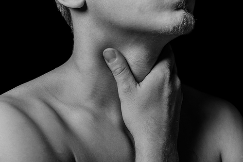 Man touches the throat, sore throat, black and white image