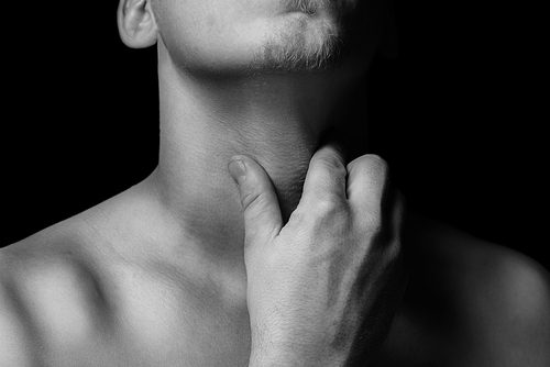 Man holds the throat, sore throat, monochrome image