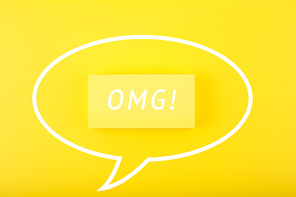 White speech bubble with OMG on bright yellow background. Bright, minimal, modern concept of emotions expression and being surprised or exited