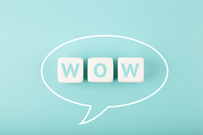 White speech bubble with wow inscription on bright tiffany blue background. Colored elegant and minimal style wow concept of expressing emotions and being excited
