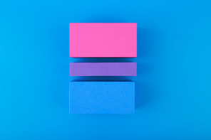 Flat lay with bisexual pride flag made of colorful blocks on blue background. Concept of lgbtq plus community, Pride month, sexual minorities and tolerance