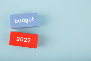 Business budget concept 2022. Budget 2022 written on colored rectangles on light blue background with copy space. Financial goals for 2022