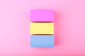 Flat lay with pansexual flag made of pink, yellow and blue rolls on bright pink background. Concept of pansexual community, sexual minorities, equal right and tolerance