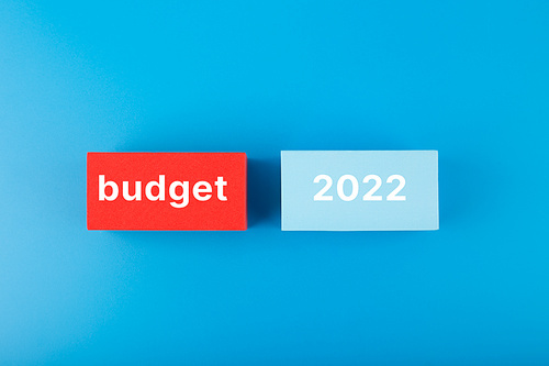 Business budget concept 2022. Budget 2022 written on colored rectangles on dark blue background. Financial goals for 2022