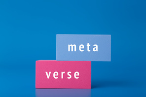 Metaverse modern minimal concept in dark elegant blue colors. Written metaverse word on blue and pink rectangles against blue background. Innovational future computer technologies.