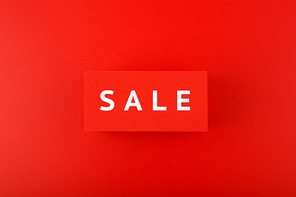 Sale elegant minimal concept in red colors. Sale written on red tablets on red background.