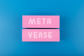 Metaverse modern minimal concept in blue colors. Written metaverse single word on two pink rectangles against dark blue background. Future computer technologies.