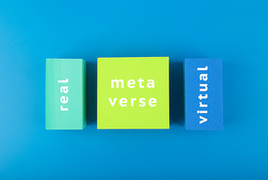 Metaverse modern creative minimal concept in blue colors. Written metaverse, real and virtual on geometric figures on dark blue background. Future technologies.