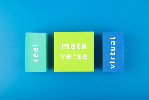 Metaverse modern creative minimal concept in blue colors. Written metaverse, real and virtual on geometric figures on dark blue background. Future technologies.