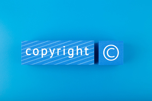 Minimal trendy copyright and patenting concept. Copyright word and symbol on blue blocks against blue background