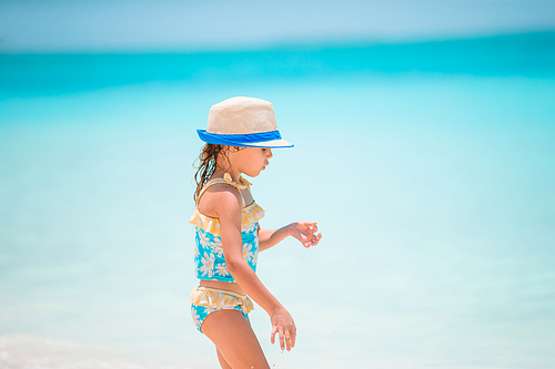 Kid fun. Little girl on the beach walking and playing