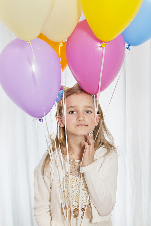 Portrait of a young girl with party balloons