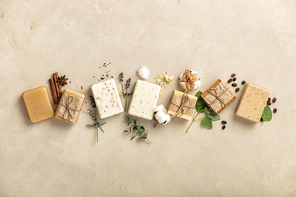 Handmade soap bars and ingredients on natural stone background, top view. Handmade organic soap concept
