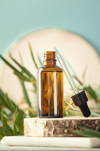Amber glass bottle and eucalyptus leaves and towels. Natural organic cosmetic packaging, luxury beauty products for body care