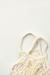 Reusable shopping bag on white background. Ecological concept. Top view of mesh shopping cotton bag. Caring for the environment and the rejection of plastic