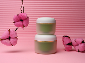 green jar for cosmetics on a pink background. Packaging for cream, gel, serum, advertising and product promotion, mock up