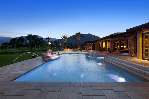 Swimming pool with fountain outside luxurious manor house