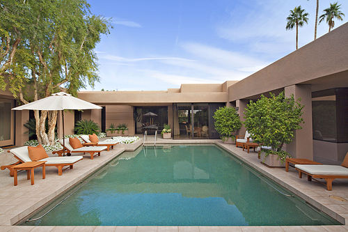 Swimming pool with chaise lounge in luxury villa