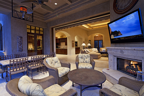 Seating furniture near fireplace with television in room of luxury villa