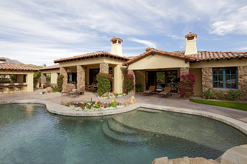 Swimming pool in front of luxurious mansion