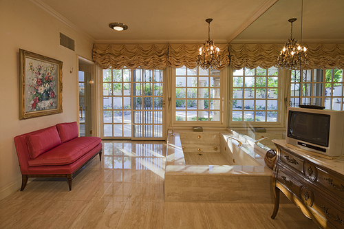 Bathtub with television in luxury room of a mansion