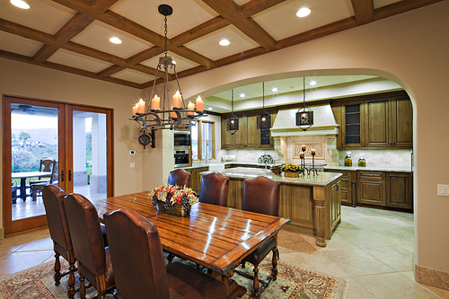 Dining table near kitchen in luxury mansion