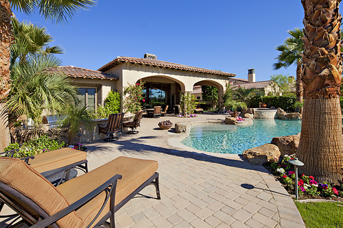 Outdoors seating furniture near swimming pool in luxury villa