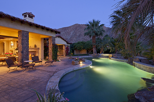 Swimming pool in luxury villa at evening with mountain in background