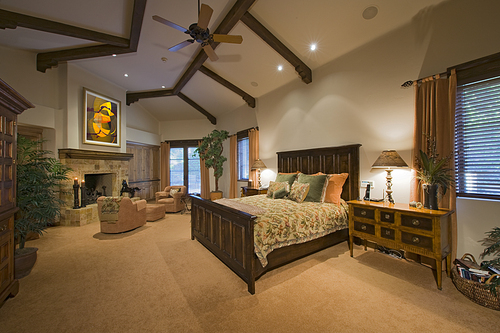 Master bedroom interior with fireplace in manor house