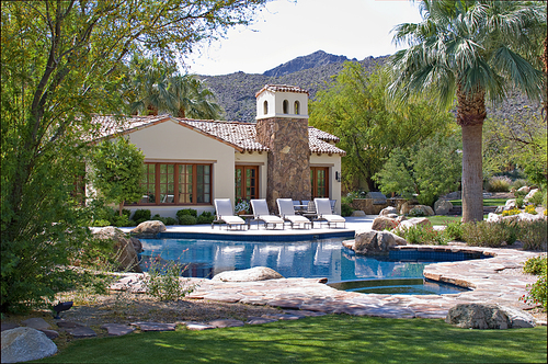 Sun loungers at poolside in luxury mansion