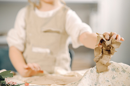 Portrait of little girl painting a ceramic model at school. Concept for art and creative education. Kids concept hobby.