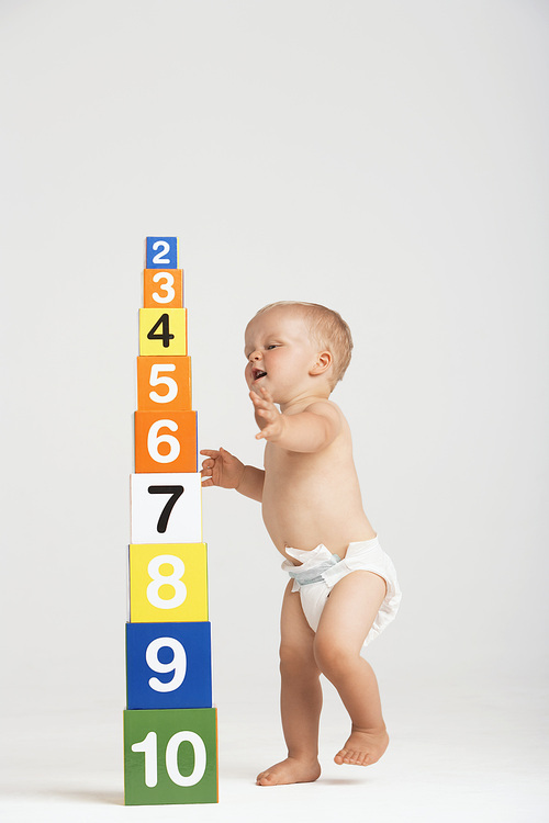 Baby Approaching Tower of Number Blocks