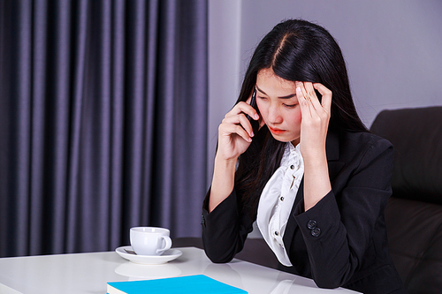 woman in business suit working in stress desperate talking on a mobile phone