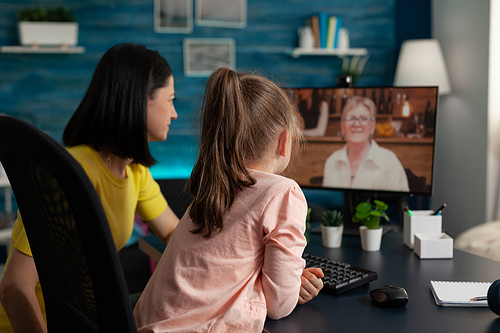 Parent and little kid meeting with grandma on video call virtual communication. Family of two using online modern conference for checking on relatives while social distancing at home