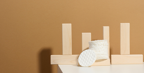 White cotton sponges on a white table. Design for the beauty, medicine and cosmetics industry